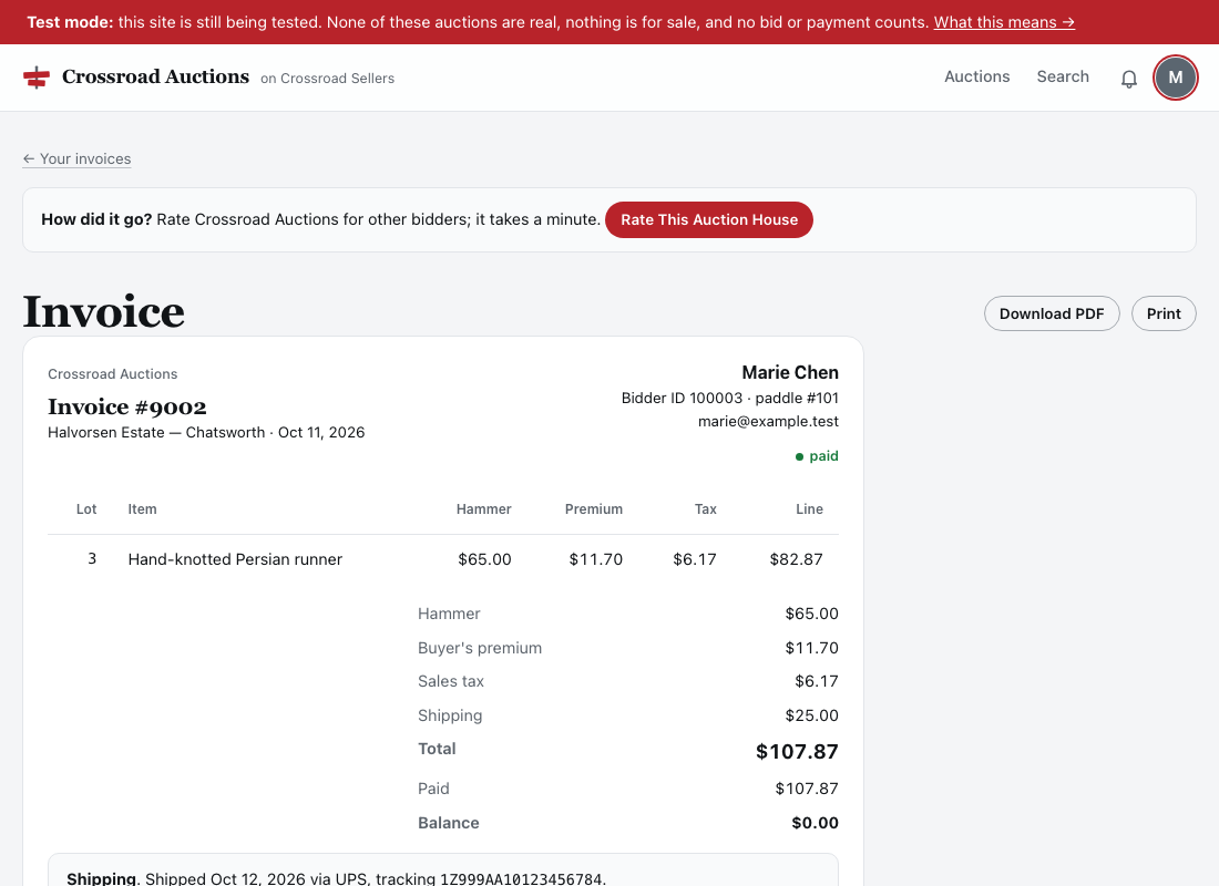 A paid invoice: Download PDF and Print at the top; the lot won with its hammer price, premium, tax and line total; then hammer, premium, tax, shipping, the total, what was paid and a balance of zero; the shipping note with the carrier and tracking number under it